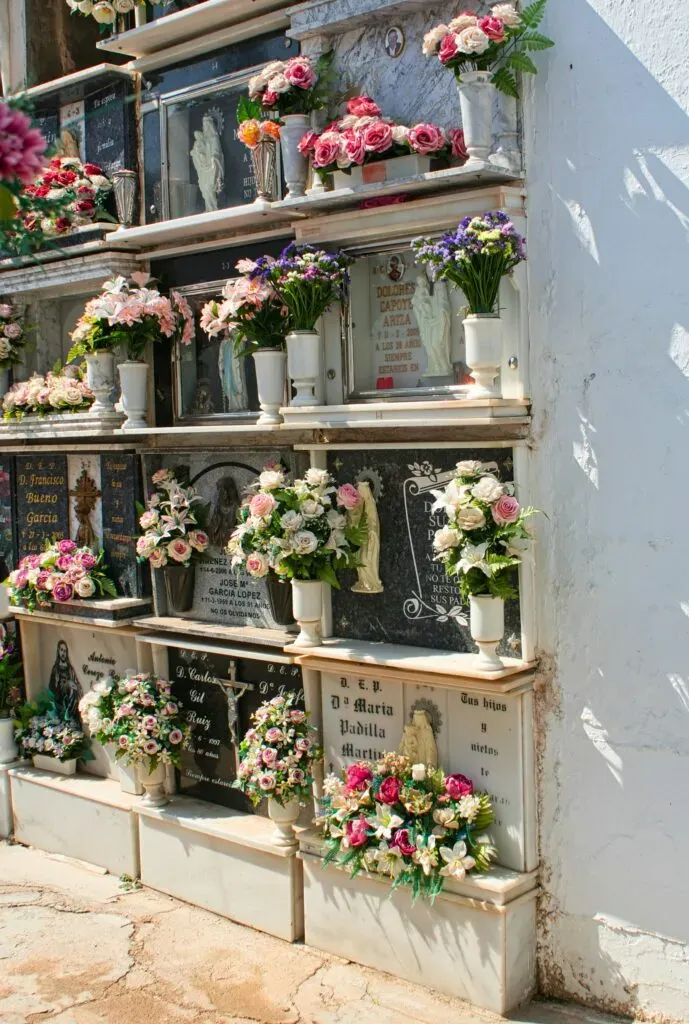 Mur de colombarium orné de compositions florales et plaques commémoratives